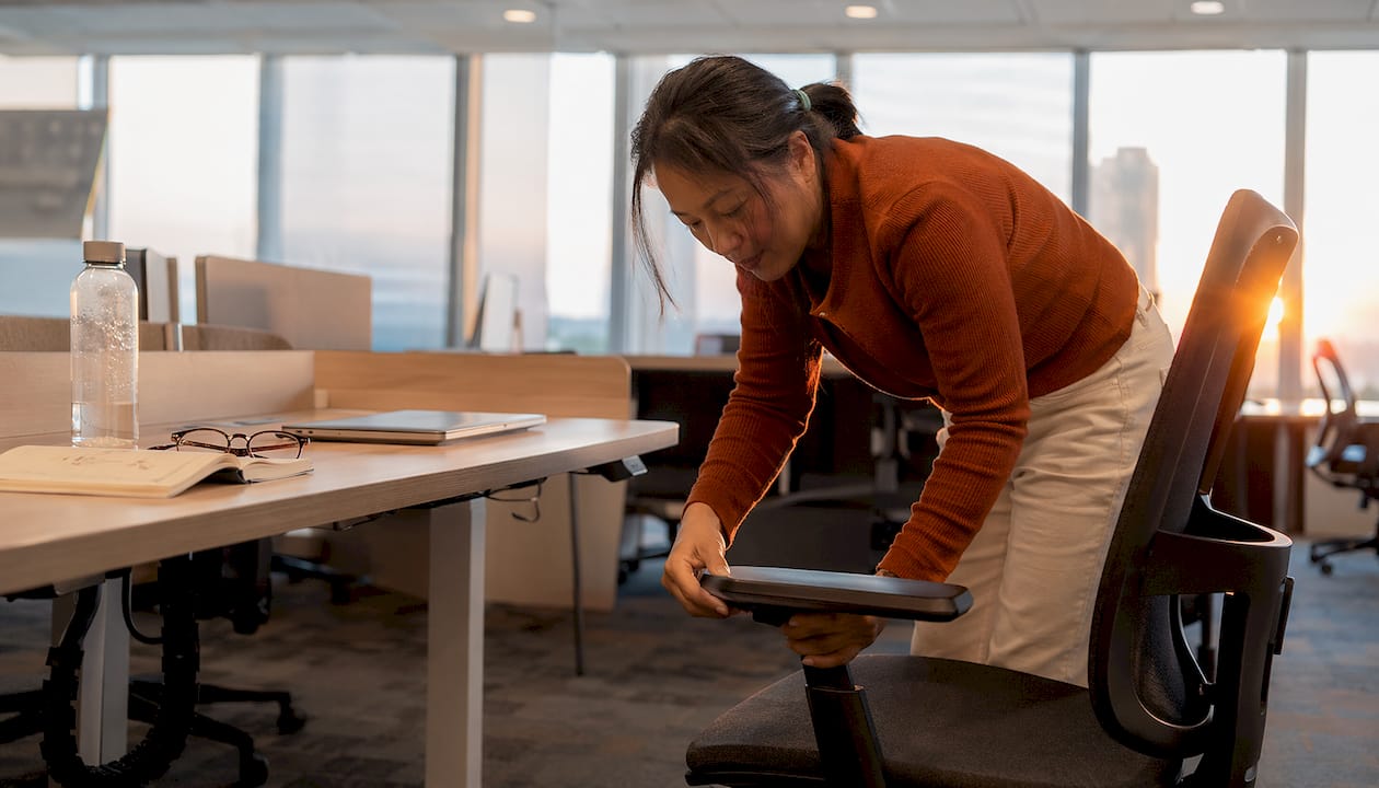 Woman adjusting ergonomic office chair
