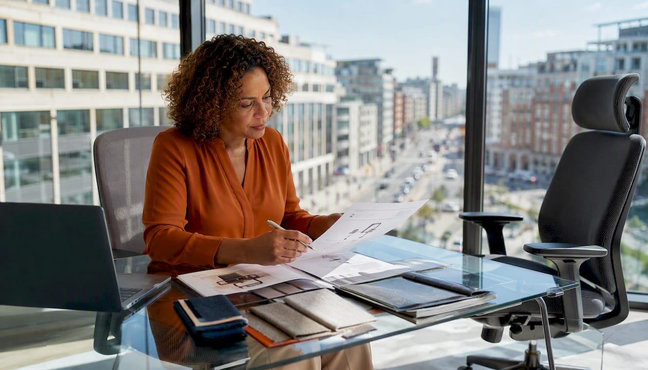 Procurement officer reviewing chair certification documents