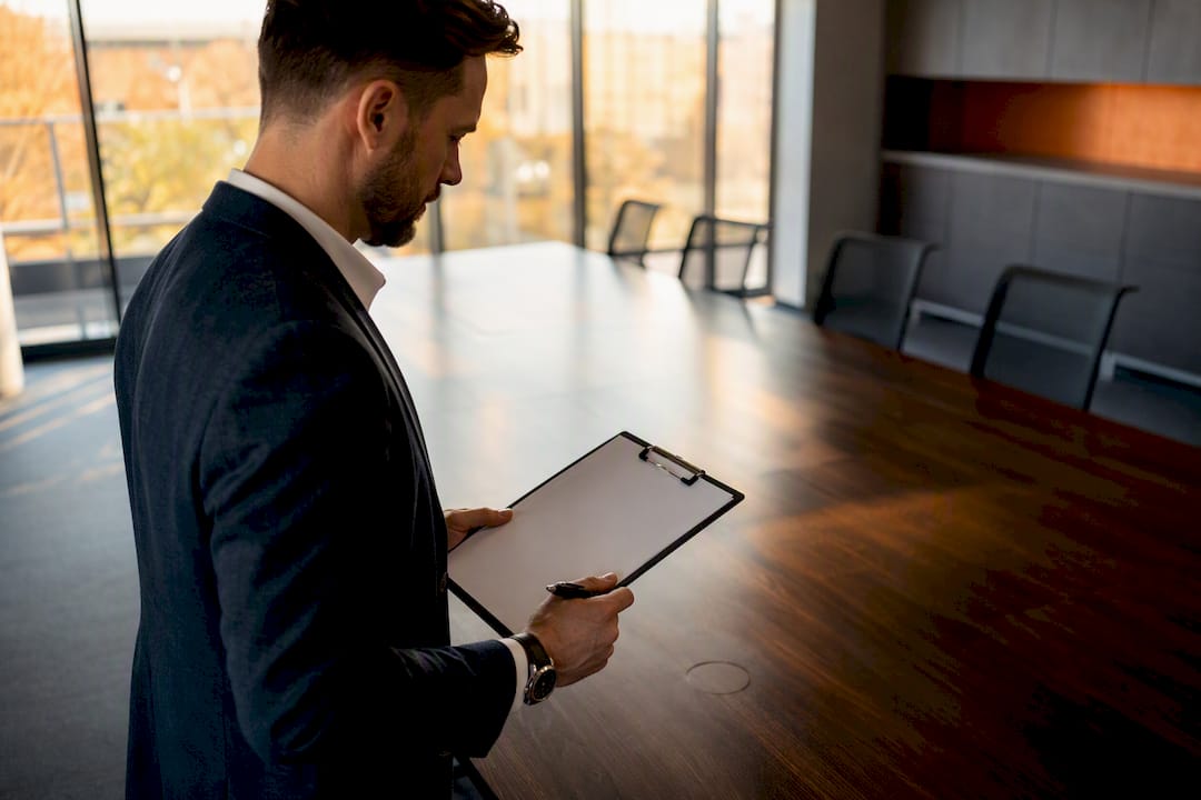Hands checking office desk surface with checklist