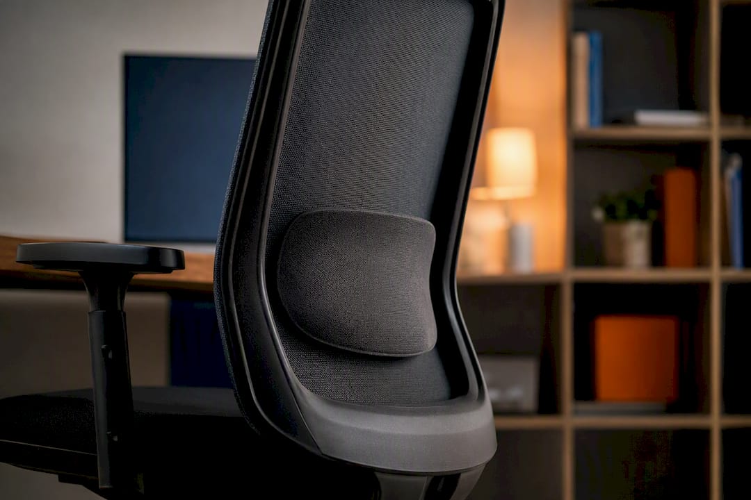 Side close-up of fixed lumbar support on chair backrest