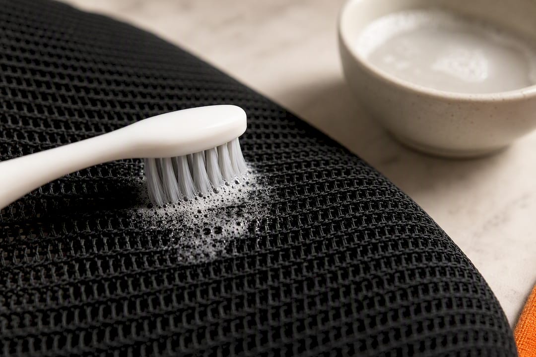 Toothbrush applying soap paste to mesh