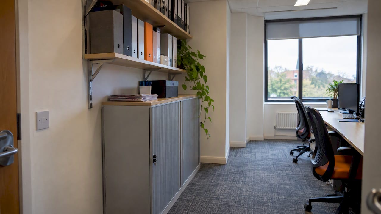 Wall shelving and tall cabinets preserve office floor space